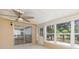 The Florida room has a ceiling fan and sliding glass doors at 7336 Cherry Laurel Dr, Port Richey, FL 34668