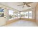 This is a sunroom with lots of windows and a ceiling fan at 7336 Cherry Laurel Dr, Port Richey, FL 34668