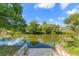 Picturesque view of the water featuring lush trees reflecting on the water at 7336 Cherry Laurel Dr, Port Richey, FL 34668