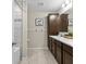 Bathroom featuring a double vanity, tile backsplash, decorative hooks and a bathtub with tiled walls at 7513 S Sherrill St, Tampa, FL 33616