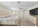 Well-lit main bedroom featuring a ceiling fan and a large dresser at 7513 S Sherrill St, Tampa, FL 33616