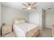 Bright bedroom with a ceiling fan, neutral walls, carpet flooring and a double door closet for storage at 7513 S Sherrill St, Tampa, FL 33616