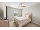 Bright bedroom featuring a ceiling fan, neutral walls, carpet flooring and a window providing natural light at 7513 S Sherrill St, Tampa, FL 33616
