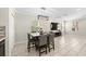 Well-lit dining area with comfortable seating, neutral walls, and a view of the adjacent living area at 7513 S Sherrill St, Tampa, FL 33616