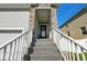 Inviting entryway with stone-accented columns and steps leading to the front door at 7513 S Sherrill St, Tampa, FL 33616