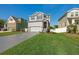 Charming two-story home featuring a manicured lawn, decorative driveway, and stone-accented entryway at 7513 S Sherrill St, Tampa, FL 33616
