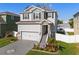 Attractive two-story home boasting stone details, a landscaped yard, and a decorative driveway at 7513 S Sherrill St, Tampa, FL 33616