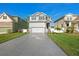 Charming two-story home featuring a manicured lawn, decorative driveway, and stone-accented entryway at 7513 S Sherrill St, Tampa, FL 33616