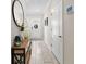 Entry hall with decorative table and round mirror at 7513 S Sherrill St, Tampa, FL 33616