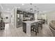 Spacious Kitchen featuring modern appliances, a large island, and an open view into the Dining Area at 7513 S Sherrill St, Tampa, FL 33616