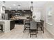 Charming kitchen and dining area with stainless steel appliances, tile floors, and dark wood cabinetry at 7513 S Sherrill St, Tampa, FL 33616
