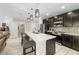 Open kitchen with granite counters, stainless steel appliances, and dark wood cabinetry at 7513 S Sherrill St, Tampa, FL 33616