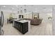 Bright and spacious living area with dining table and adjacent kitchen features an open floor plan at 7513 S Sherrill St, Tampa, FL 33616