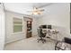 Office space featuring carpet floors, ceiling fan, desk with computer, and a bookshelf at 7513 S Sherrill St, Tampa, FL 33616