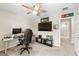 Office space featuring carpet floors, ceiling fan, desk with computer, and a TV at 7513 S Sherrill St, Tampa, FL 33616