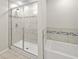 Modern glass shower with decorative tile and rain shower head at 7513 S Sherrill St, Tampa, FL 33616