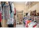 Walk in closet with custom shelving, hanging racks, and ample storage at 8198 Terrace Garden N Dr # 411, St Petersburg, FL 33709