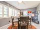 Bright dining area featuring seating for four, a colorful rug, and plantation shutters at 8198 Terrace Garden N Dr # 411, St Petersburg, FL 33709