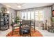 Bright dining area featuring an orange rug, seating for four, and large windows with plantation shutters at 8198 Terrace Garden N Dr # 411, St Petersburg, FL 33709