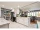 Bright and airy kitchen with marble tile flooring, white cabinets and granite countertops at 8198 Terrace Garden N Dr # 411, St Petersburg, FL 33709