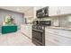 Stylish kitchen with white cabinets, marble flooring, and stainless steel appliances at 8198 Terrace Garden N Dr # 411, St Petersburg, FL 33709