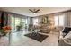 Comfortable living room with neutral furniture, stylish decor, and access to the balcony at 8198 Terrace Garden N Dr # 411, St Petersburg, FL 33709