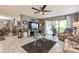 Spacious living room with plush seating, modern ceiling fan, and glass coffee table at 8198 Terrace Garden N Dr # 411, St Petersburg, FL 33709