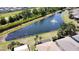 An aerial view captures the community lake and fountain, with mature landscaping and pristine lawns at 832 King Leon Way, Sun City Center, FL 33573