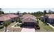 An aerial view of this cozy home boasts meticulous landscaping, a two-car garage, and a serene neighborhood setting at 832 King Leon Way, Sun City Center, FL 33573