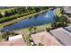 An aerial view showcasing the community lake with a fountain, surrounding homes, and lush landscapes at 832 King Leon Way, Sun City Center, FL 33573