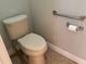 Bathroom featuring a toilet, grab bar, and toilet paper holder at 832 King Leon Way, Sun City Center, FL 33573