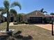 Charming single-story home featuring a well-manicured lawn, two-car garage, and lush tropical landscaping at 832 King Leon Way, Sun City Center, FL 33573