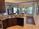 Open-concept kitchen with granite countertops, stainless steel appliances, and views of the outdoor space at 832 King Leon Way, Sun City Center, FL 33573