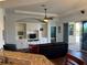 Spacious living room showcases custom built-in shelves, dark wood floors, and a seamless flow to the outdoor living area at 832 King Leon Way, Sun City Center, FL 33573