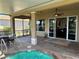 Covered, screened patio with a hot tub, a dining table, and seamless access to the home's interior at 832 King Leon Way, Sun City Center, FL 33573