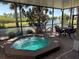 Relax in the hot tub on the screened patio overlooking a peaceful pond with fountain views at 832 King Leon Way, Sun City Center, FL 33573