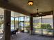 Spacious screened patio offers beautiful pond views, a ceiling fan, and a comfortable seating area at 832 King Leon Way, Sun City Center, FL 33573