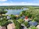 Beautiful aerial view of home nestled in a lush, green landscape near a serene lake at 8376 Golden Prairie Dr, Tampa, FL 33647