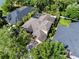 Beautiful view of the home showcasing backyard, lush landscaping, and caged pool within a well-maintained neighborhood at 8376 Golden Prairie Dr, Tampa, FL 33647