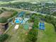 Aerial view of community with pool, tennis courts, and other amenities at 8376 Golden Prairie Dr, Tampa, FL 33647