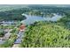 Aerial view of a lakeside home, surrounded by lush greenery and trees at 8376 Golden Prairie Dr, Tampa, FL 33647