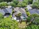 Aerial view of backyard with screened pool, patio, and mature landscaping at 8376 Golden Prairie Dr, Tampa, FL 33647