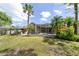 Spacious backyard featuring a screened pool, patio, and beautiful tropical landscaping at 8376 Golden Prairie Dr, Tampa, FL 33647