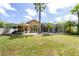 Expansive backyard featuring a screened pool, patio, and lush landscaping for ultimate outdoor enjoyment at 8376 Golden Prairie Dr, Tampa, FL 33647
