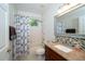 Bright bathroom with a granite countertop vanity, mosaic backsplash and shower-tub combo at 8376 Golden Prairie Dr, Tampa, FL 33647