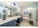 Well-lit bathroom with double vanity, large mirror, and separate bathtub surrounded by stylish glass block accents at 8376 Golden Prairie Dr, Tampa, FL 33647
