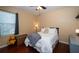 Well-lit bedroom featuring wood floors, a ceiling fan and a comfortable twin bed at 8376 Golden Prairie Dr, Tampa, FL 33647