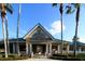Welcoming community clubhouse featuring a covered entrance and manicured landscaping at 8376 Golden Prairie Dr, Tampa, FL 33647