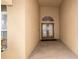 Inviting entryway with a covered porch, decorative glass door, and tiled flooring at 8376 Golden Prairie Dr, Tampa, FL 33647