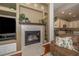 Living room with a built-in fireplace with decorative shelving at 8376 Golden Prairie Dr, Tampa, FL 33647